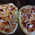 Shallot slices on pizza